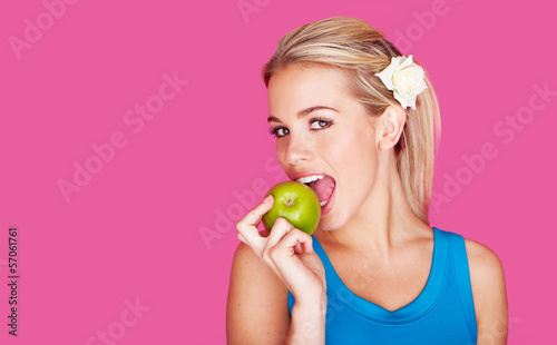 Beautiful woman biting into an apple