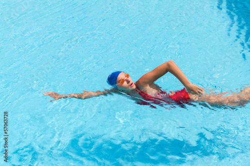 Woman swims freestyle in the pool