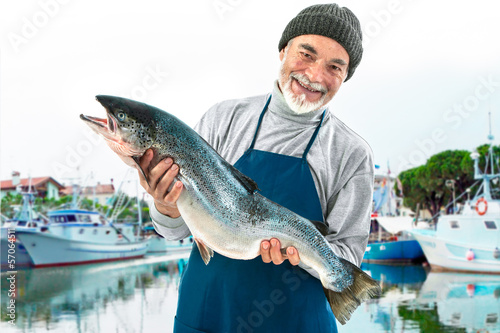 Fisherman holding a big atlantic salmon fish photo