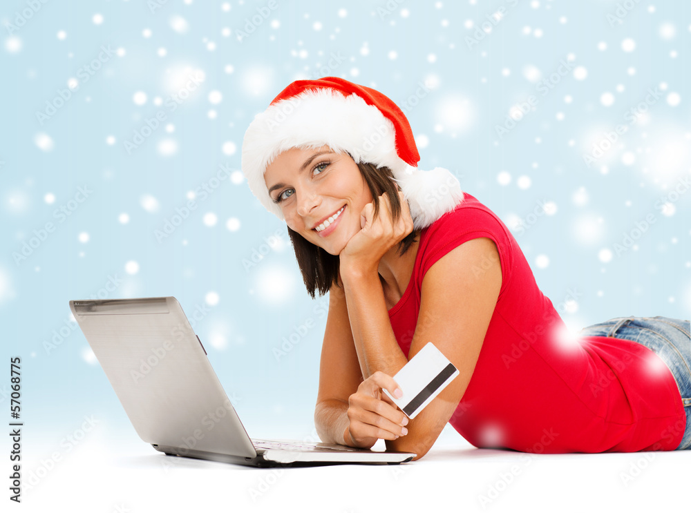 woman in santa hat with laptop and credit card