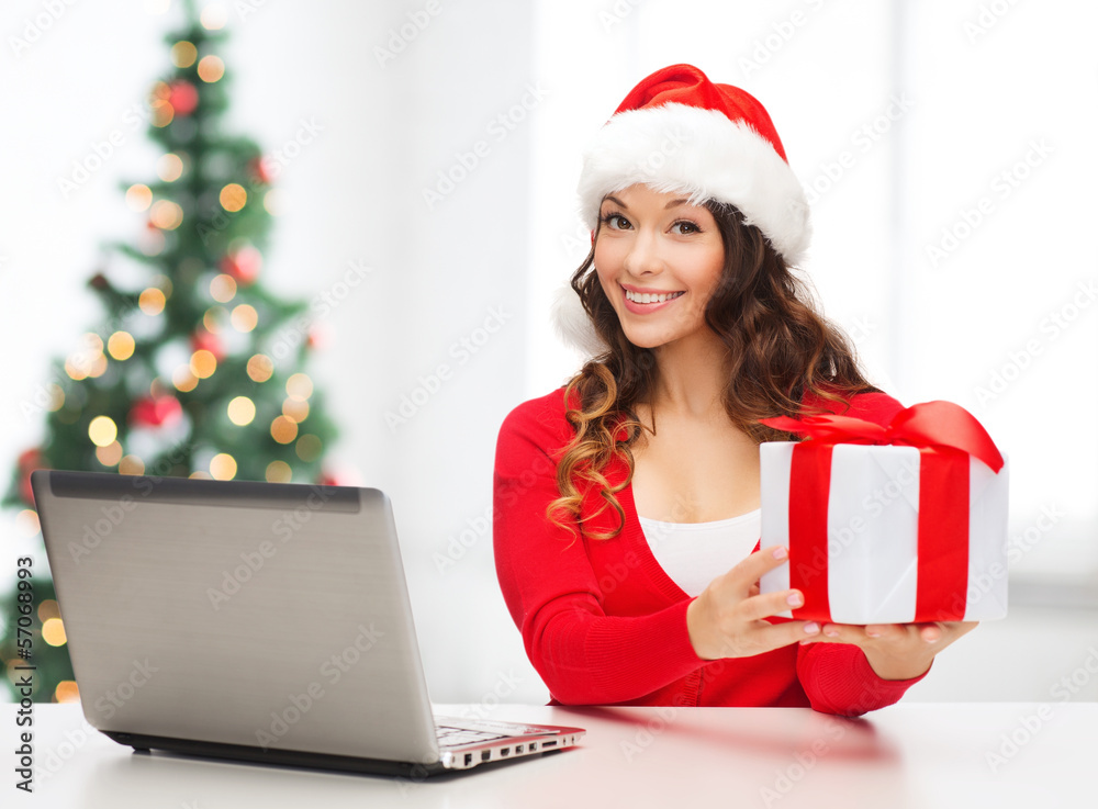 woman with gift box and laptop computer woman with gift box and laptop computer