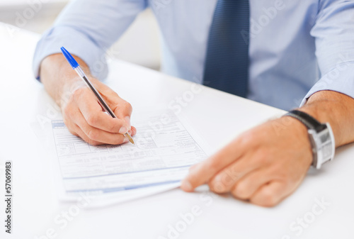 man signing a contract
