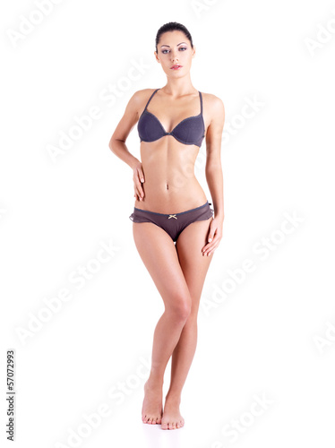 Full body of a young woman in a grey bikini