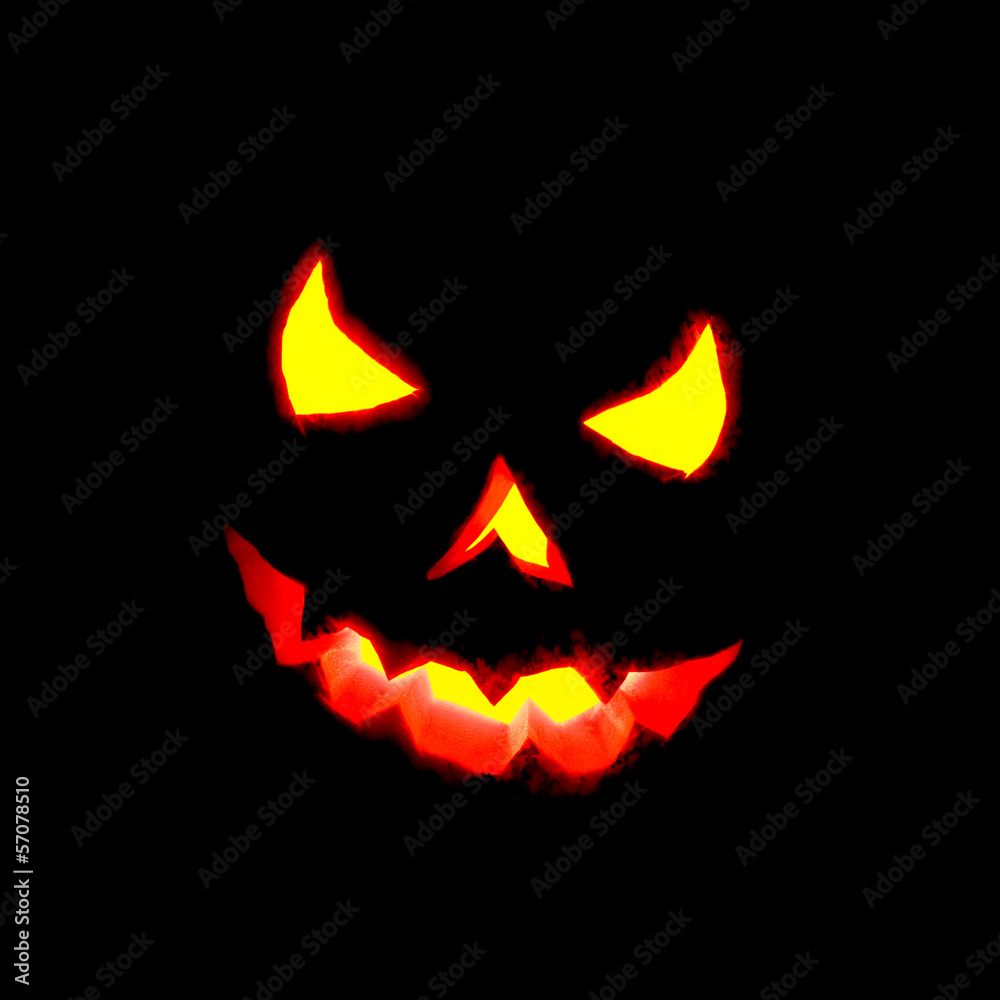 Naklejka premium Glowing Halloween pumpkin isolated on black.