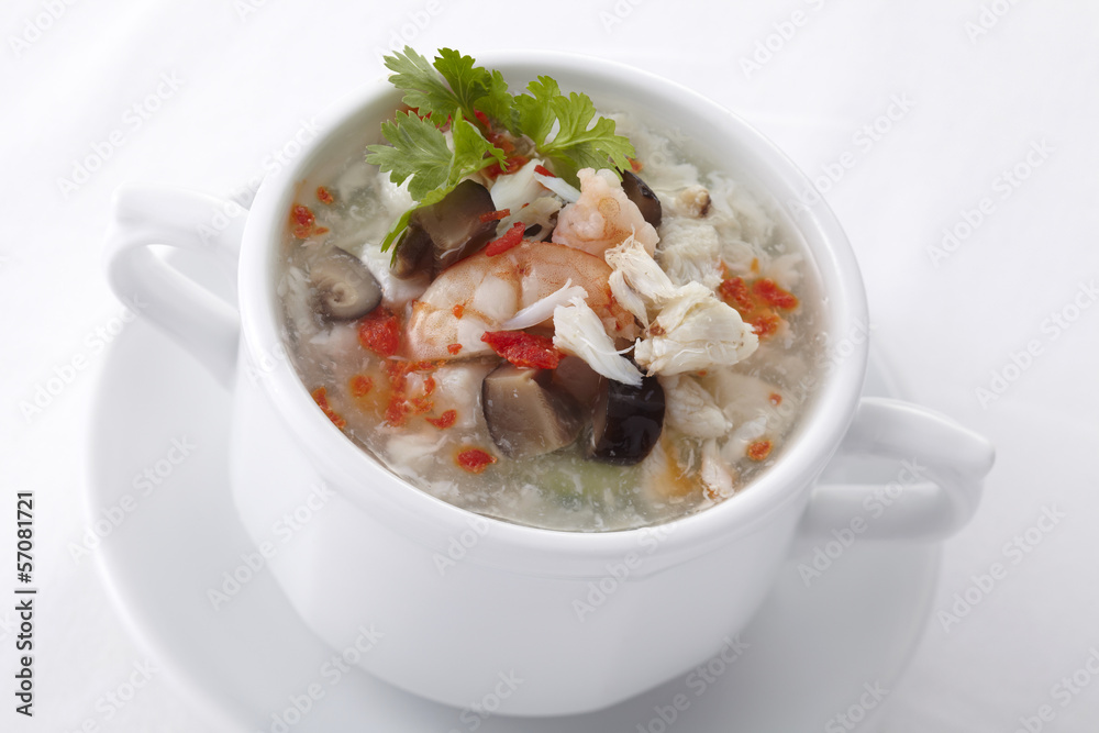 Chinese egg soup with seafood in white bowl Chinese egg soup with seafood in white bowl