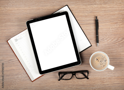 Tablet with blank screen and coffee cup