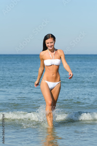 Attractive woman bathes at the sea