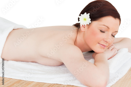 Portrait of a serene red-haired woman posing while relaxing in a