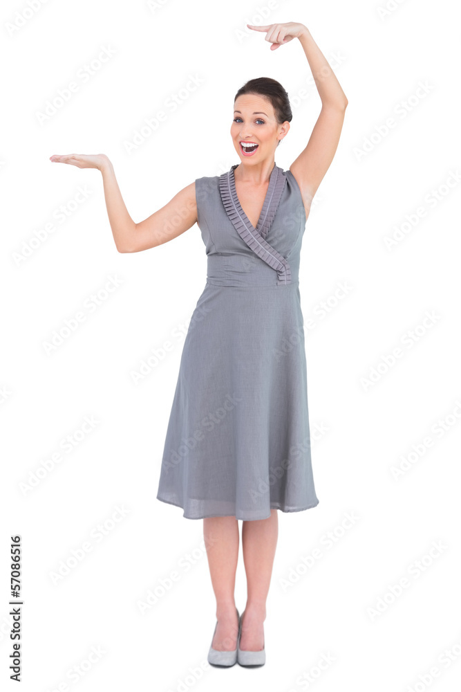 Cheerful elegant woman in classy dress showing direction Cheerful elegant woman in classy dress showing direction