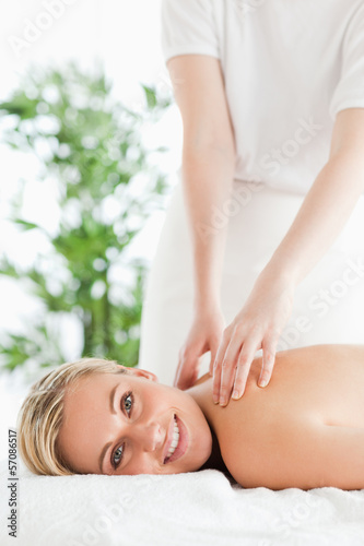 Good looking woman relaxing on a lounger during massage