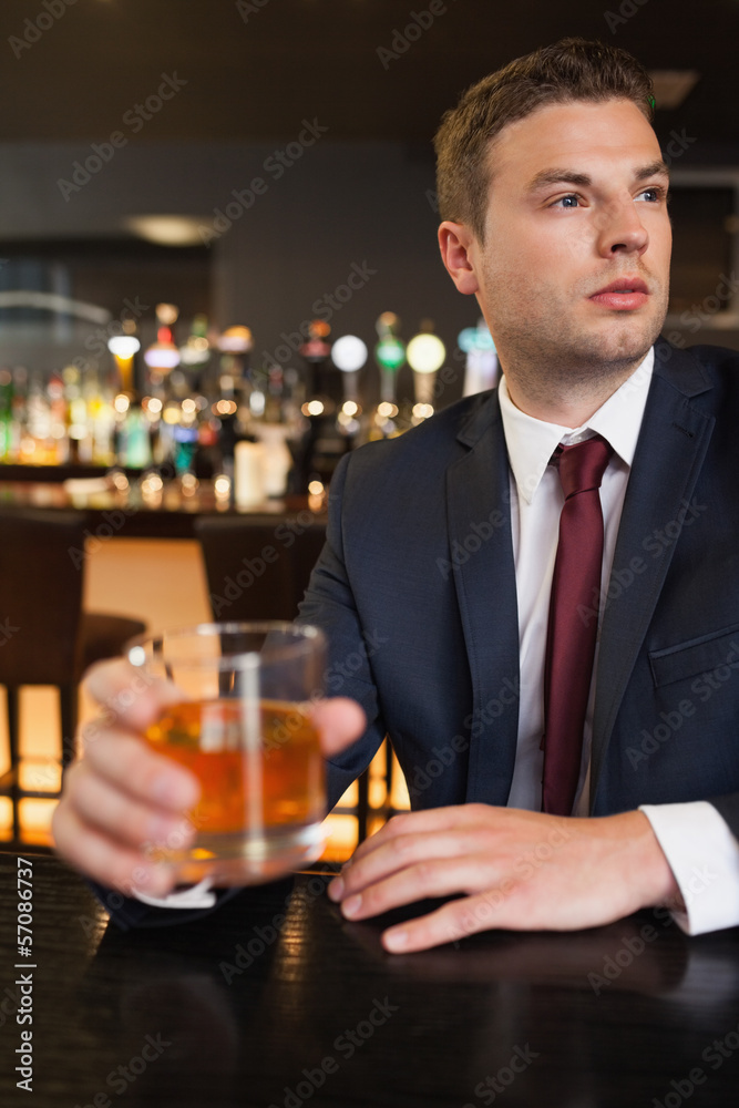 Thoughtful businessman having a drink Thoughtful businessman having a drink