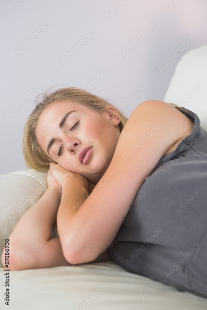Obraz premium Casual attractive blonde lying on couch sleeping