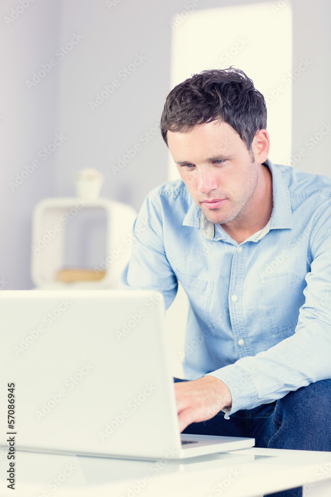 Handsome casual man using laptop Handsome casual man using laptop