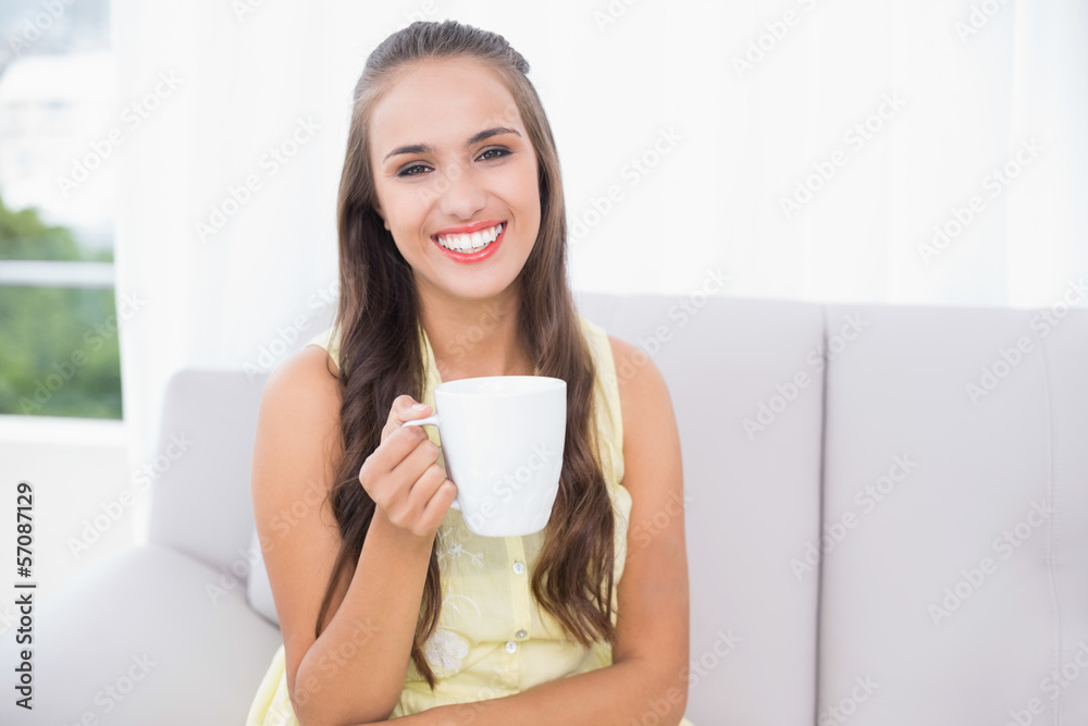 Cheerful young brunette holding a mug Cheerful young brunette holding a mug