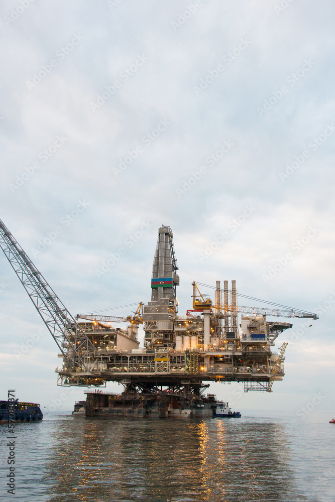Fototapeta premium Oil rig being tugged in the sea
