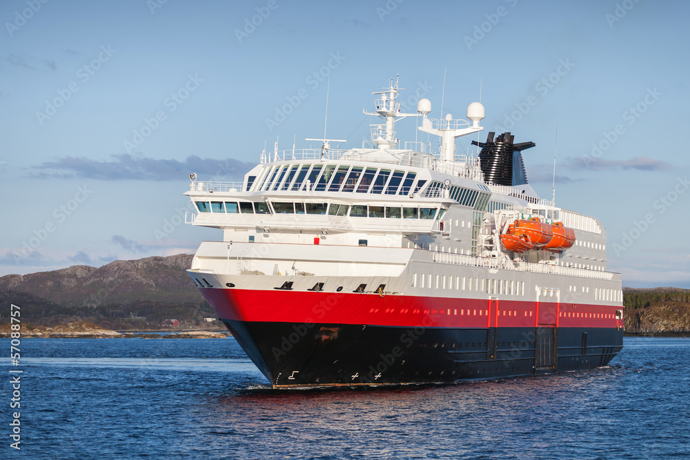 Fototapeta premium Big Norwegian passenger cruise ship sails in fjord