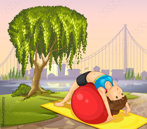 A girl keeping her body fit near the tree