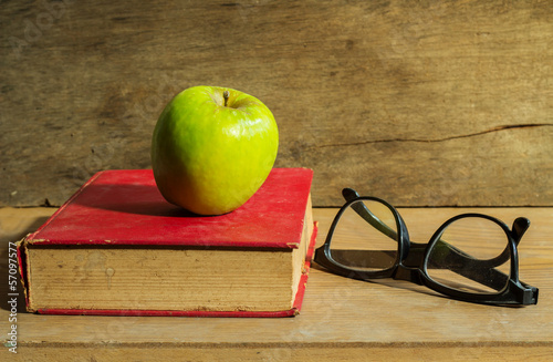 Antique book with apple