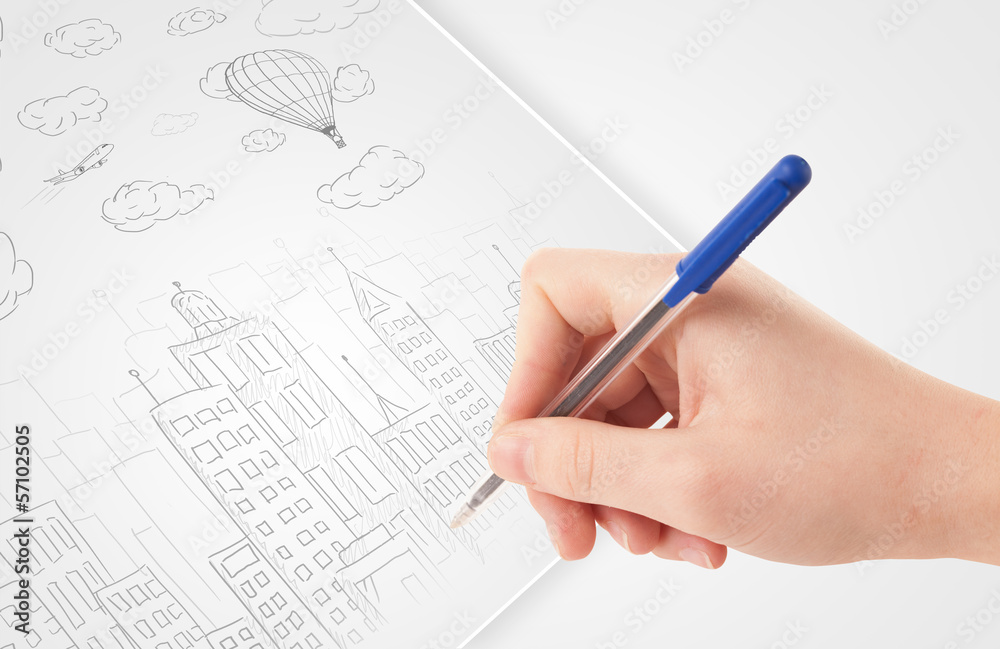 A person drawing sketch of a city with balloons and clouds on a A person drawing sketch of a city with balloons and clouds on a