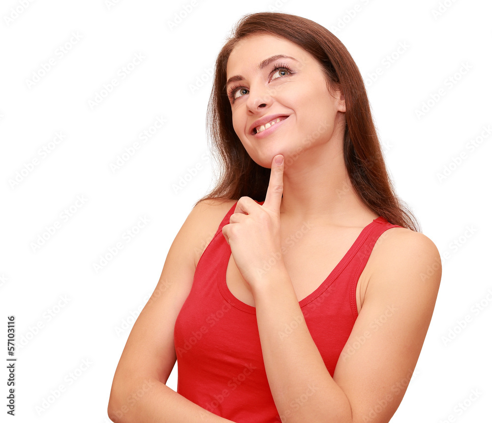 Beautiful thinking student girl looking up with finger at face i Beautiful thinking student girl looking up with finger at face i