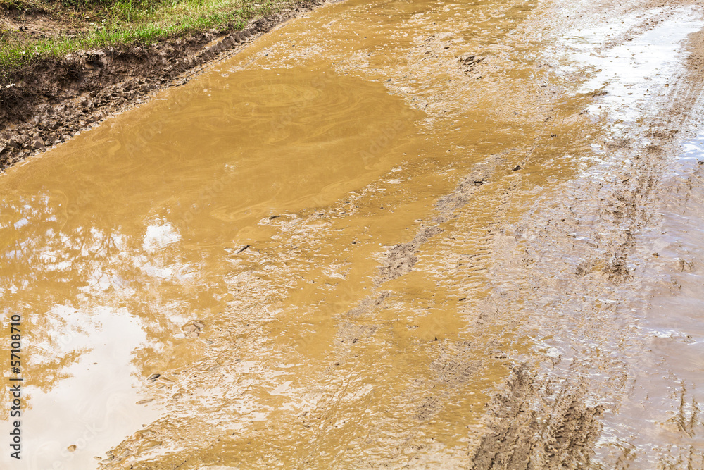 mud and puddle in rut of dirt ground road mud and puddle in rut of dirt ground road