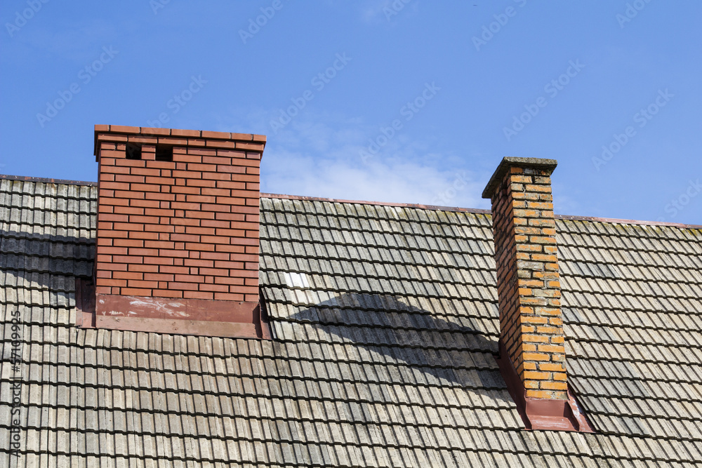 Fototapeta premium two brick chimneys on the roof