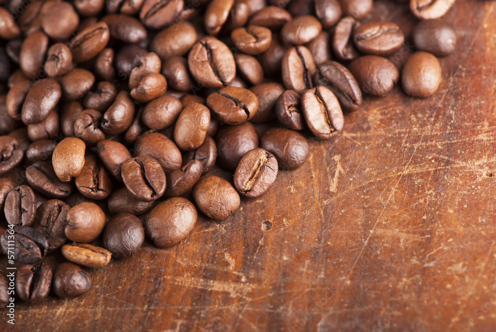 grains of coffee on a wooden background grains of coffee on a wooden background