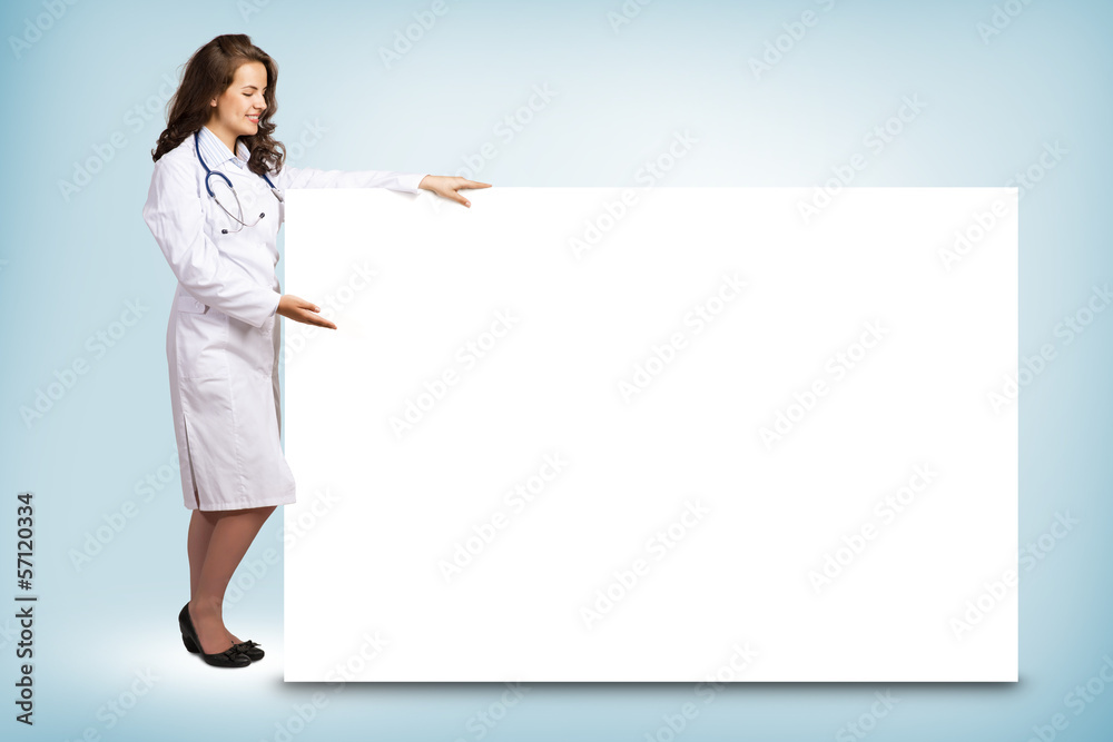 young woman doctor standing near a blank banner young woman doctor standing near a blank banner