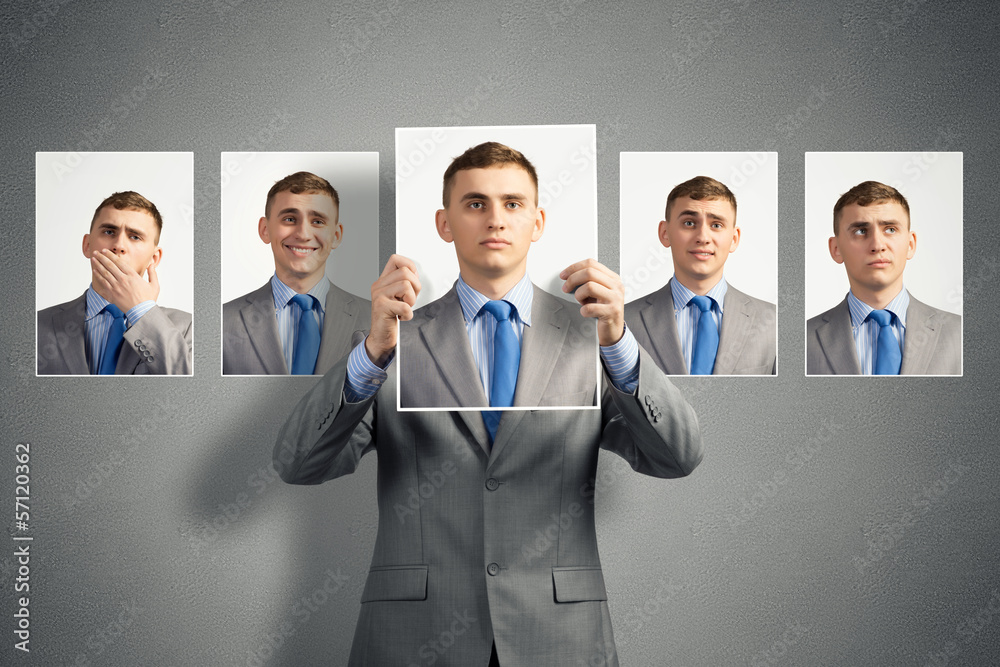 young man holds up a photograph