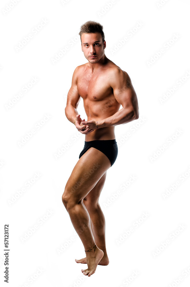 Handsome athletic young man in bodybuilder pose, isolated