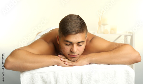 Young man relaxed in spa salon