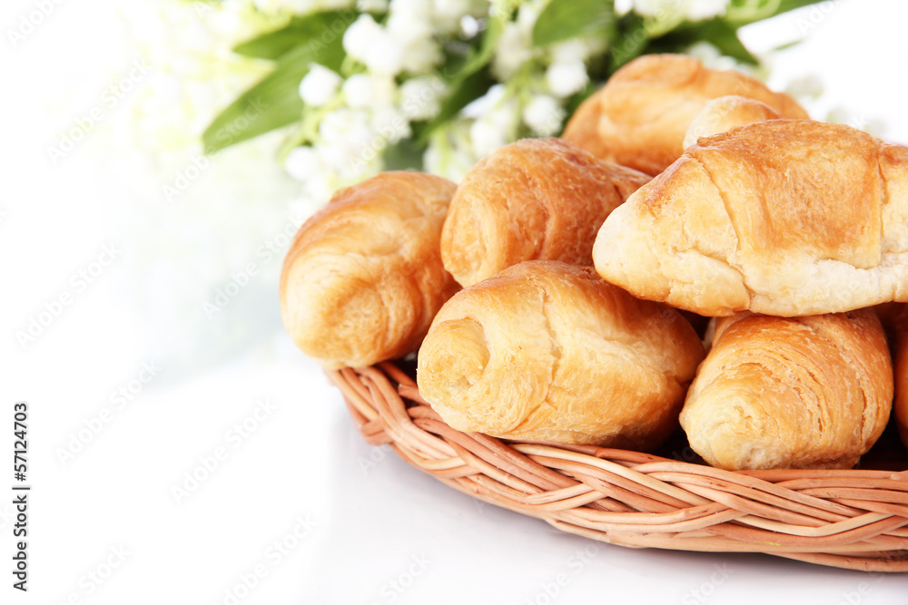 Tasty croissants on wicker mat isolated on white Tasty croissants on wicker mat isolated on white