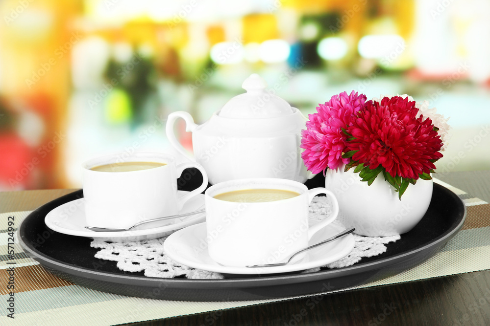 Cups of coffee on tray on table in cafe Cups of coffee on tray on table in cafe