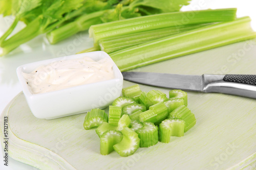 Fresh green celery on cutting board close-up