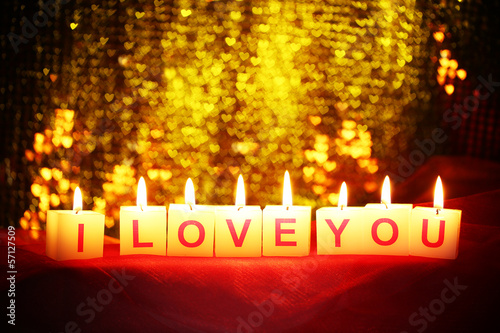 Candles with printed sign I LOVE YOU,on blur lights background