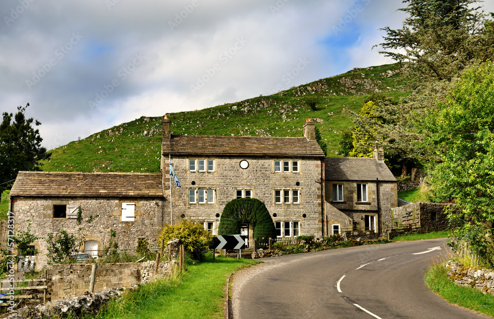 Stone built cottage by a road
