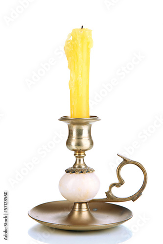 Old candleholder with candle isolated on white