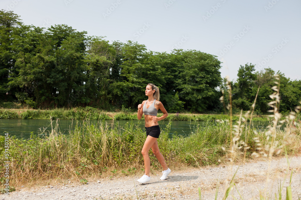 Beautiful blonde woman is doing running workout Beautiful blonde woman is doing running workout