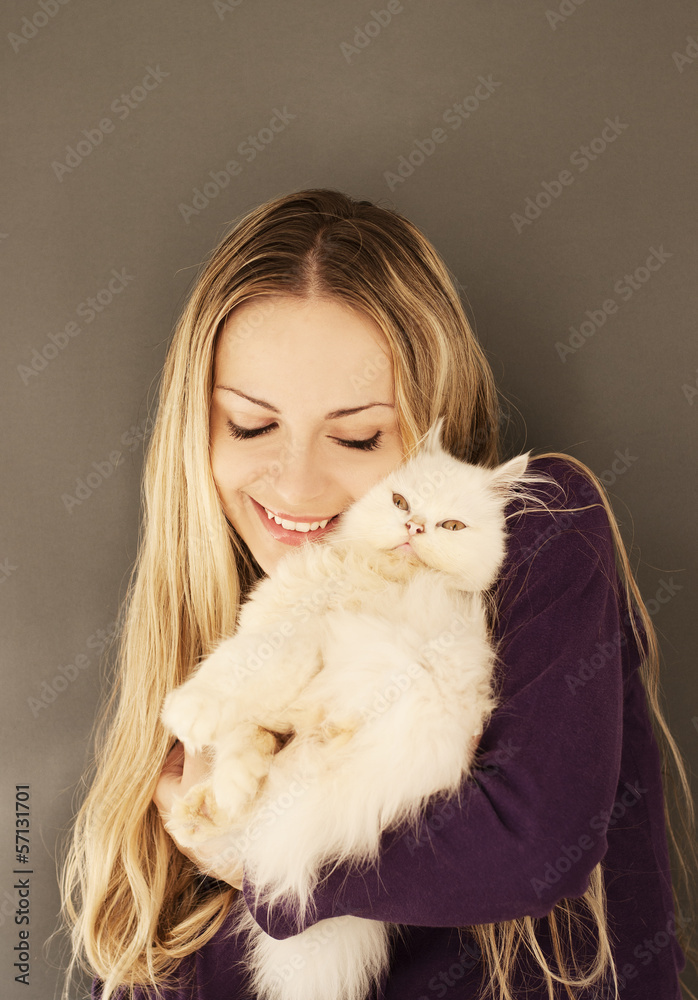 Beautiful young woman holding white Persian kitten Beautiful young woman holding white Persian kitten