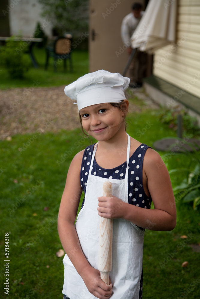 Happy girl with rolling pin Happy girl with rolling pin