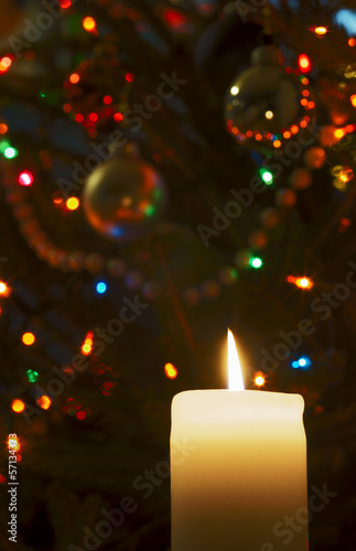 Flame of candle and Christmas tree ornaments.
