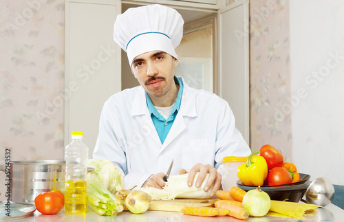 Portrait of male cook with lettuce
