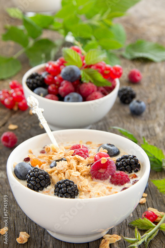 breakfast - muesli with berries, milk, selective focus.