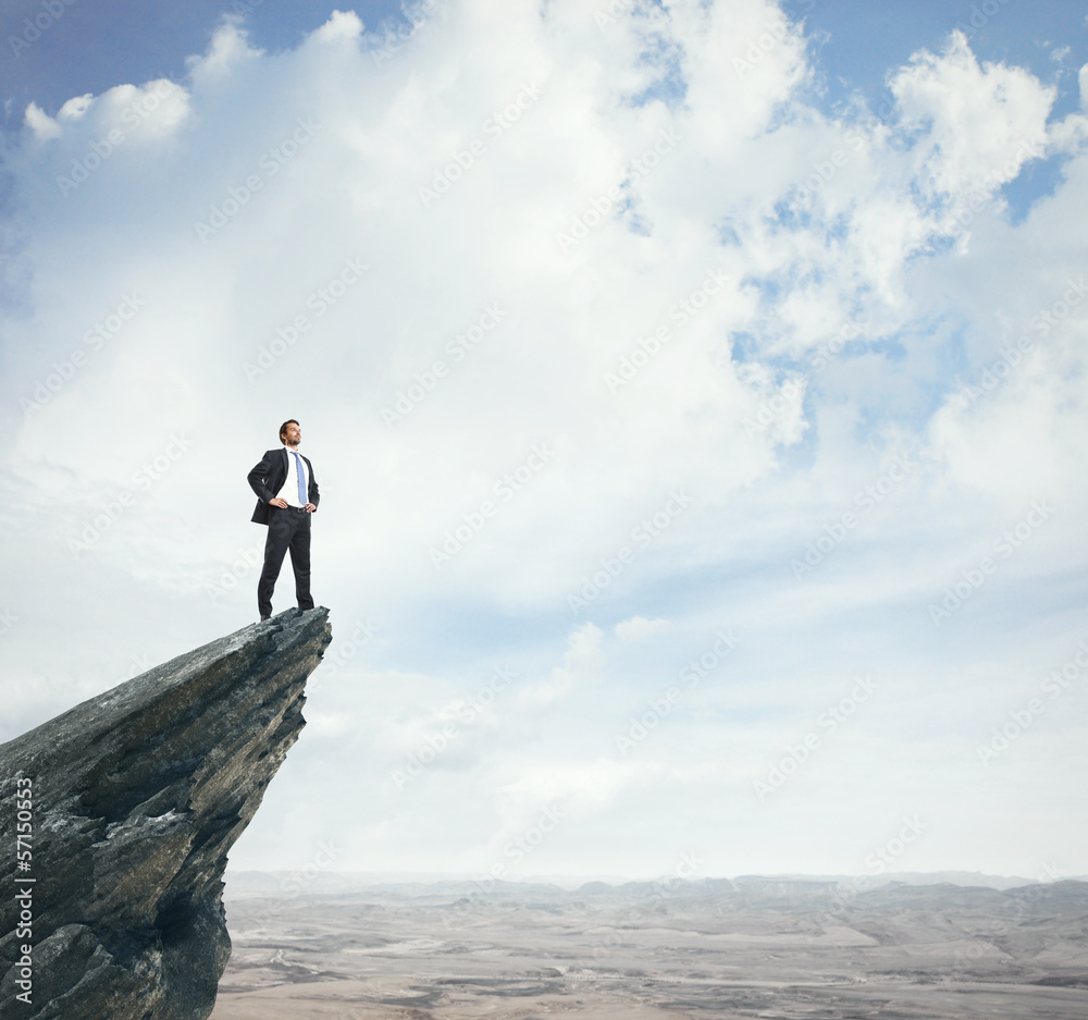 businessman standing on a peak