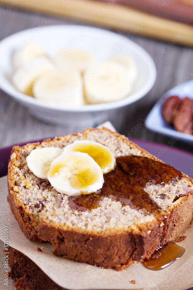 Slice of banana cake with pecans and maple syrup Slice of banana cake with pecans and maple syrup