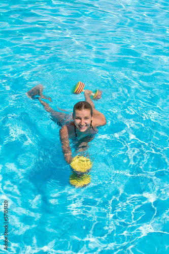 Aqua aerobic, woman in water with dumbbells