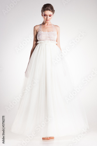 beautiful woman model posing in elegant white dress