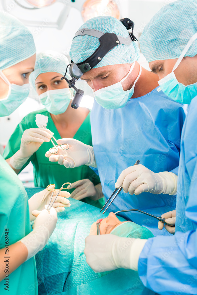 Surgeons operating patient in operation theater Surgeons operating patient in operation theater