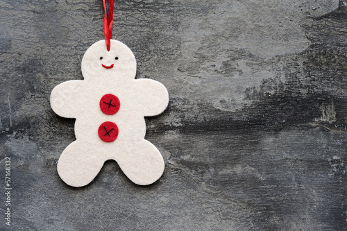Generic machine made Christmas gingerbread man ornament on rusti