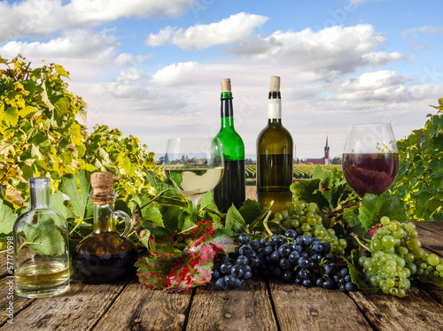 Grapes, wine glasses and bottles in the vineyard